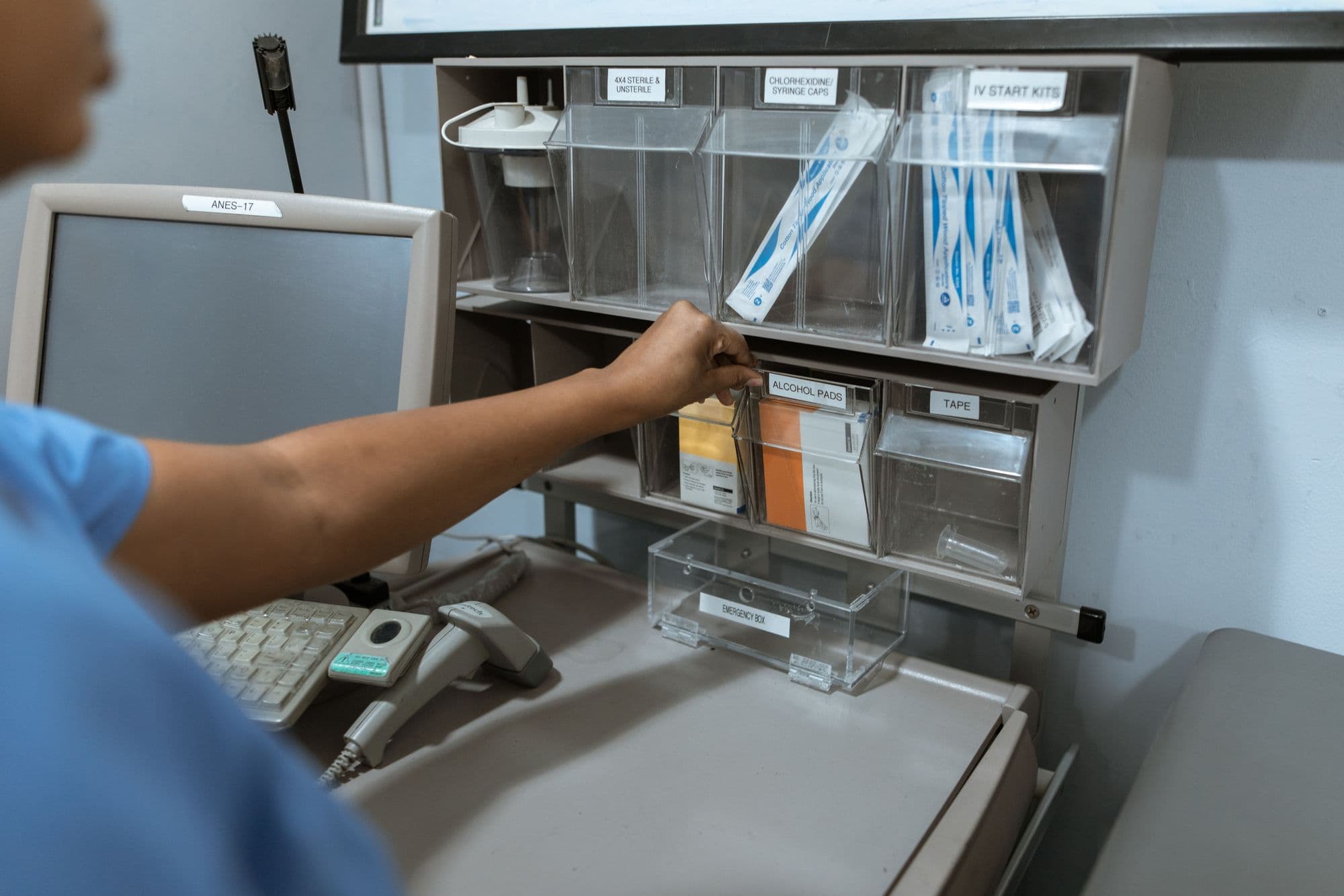 Medical professional organizing healthcare supplies on shelving